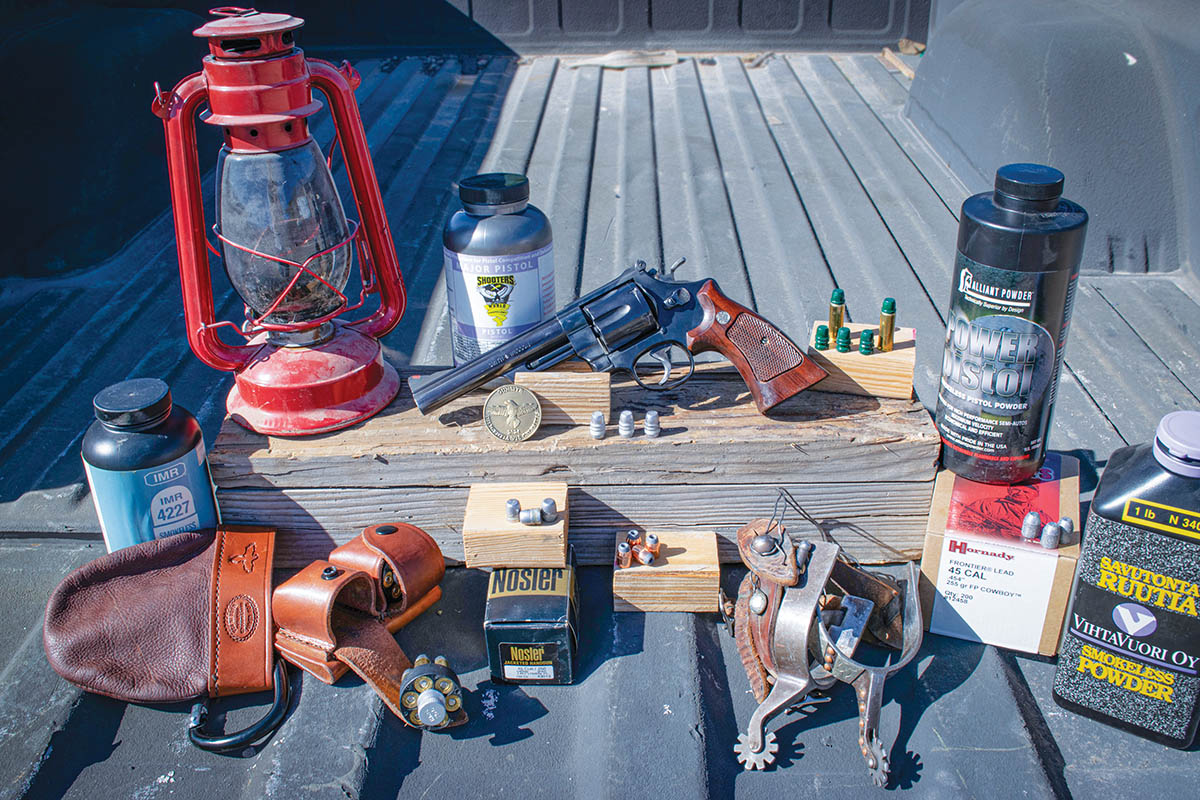 A favorite of the author is this Smith & Wesson Model 25-5 with a 6-inch barrel chambered in 45 Colt shown alongside some favorite components and equipment – notably the mini dump pouch and Double Speed Loader Pouch, both made by Simply Rugged Holsters in Arizona.